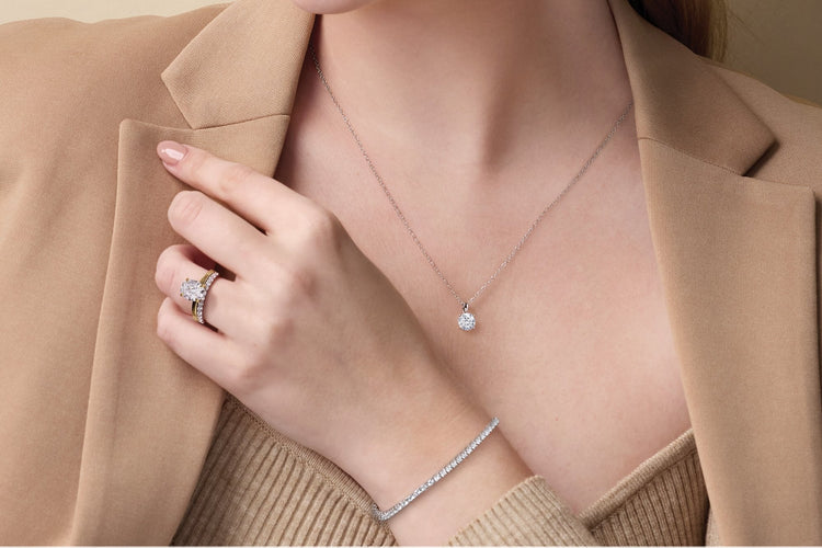 Diamond ring, solitaire necklace, and tennis bracelet worn together