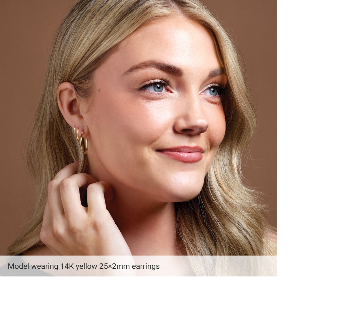Model wearing 14K gold hoop earrings
